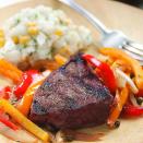 <p>Here, we toss colorful bell peppers in a balsamic-herb vinaigrette and grill them in a foil packet at the same time as the steak for a no-fuss dinner for two. Serve with corn on the cob.</p>