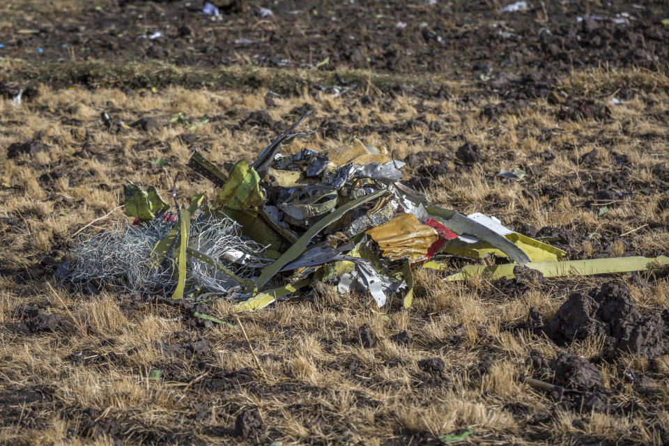 A pile of debris on the ground at Bishoftu, or Debre Zeit, outside Addis Ababa, Ethiopia, Monday, March 11, 2019, where Ethiopia Airlines Flight 302 crashed Sunday. Investigators are trying to determine the cause of a deadly crash Sunday involving a new aircraft model touted for its environmentally friendly engine that is used by many airlines worldwide. (AP Photo/Mulugeta Ayene)