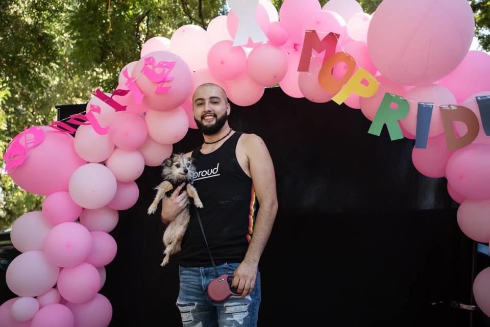 Rafa Arroyo poses for a picture with his dog Bella during the MoPride festival at Graceada Park in Modesto, Calif., Saturday, Oct. 1, 2022. Andy Alfaro/aalfaro@modbee.com