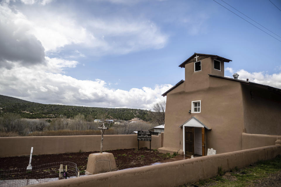 An exterior view of St. Anthony's Catholic church, in Cordova, New Mexico, Friday, April 14, 2023. Ever since missionaries started building churches out of mud 400 years ago in what was the isolated frontier of the Spanish empire, tiny mountain communities like Cordova relied on their own resources to keep the faith going. (AP Photo/Roberto E. Rosales)