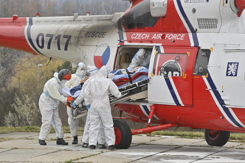 Health workers at the Motol University Hospital take out of army helicopter one of the patients with COVID-19, who was transported to Prague from a hospital in Brno, Czech Republic, Thursday, Nov. 25, 2021. COVID spread reaches another record in Czech Republic, with 27,717 new confirmed COVID cases on Thursday, another daily maximum since the start of the epidemic. (Vit Simanek / CTK via AP)