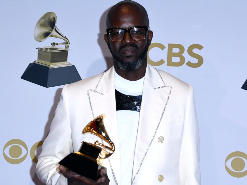 DJ Black Coffee posing with his award at the 2022 Grammys.