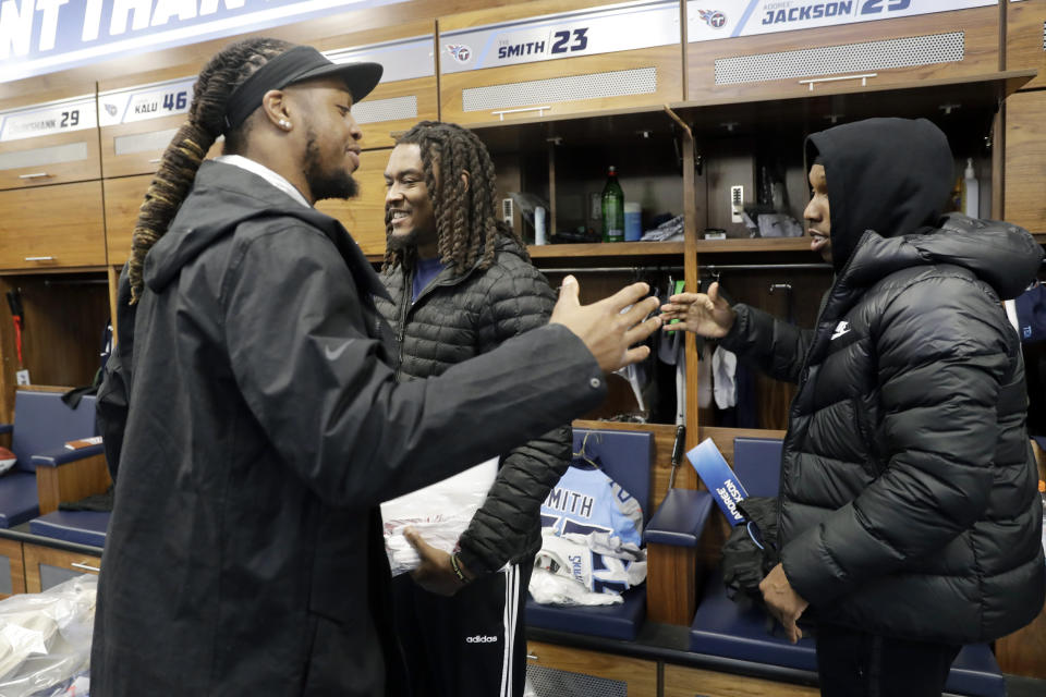 Tennessee Titans running back Derrick Henry, left, says goodbye to cornerback Tye Smith, center, and cornerback Adoree' Jackson, right, as players clean out their lockers Monday, Jan. 20, 2020, in Nashville, Tenn. The Titans lost the AFC Championship NFL football game Sunday to the Kansas City Chiefs. (AP Photo/Mark Humphrey)