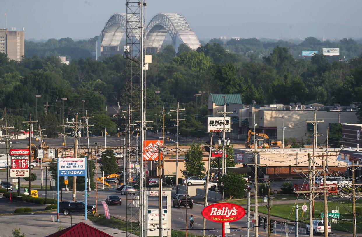 A cyclist pedals north on State Street in New Albany, Indiana at dusk Tuesday. Temperatures were expected to hit in the high 90s with heat index around 110 degrees. June 14, 2022