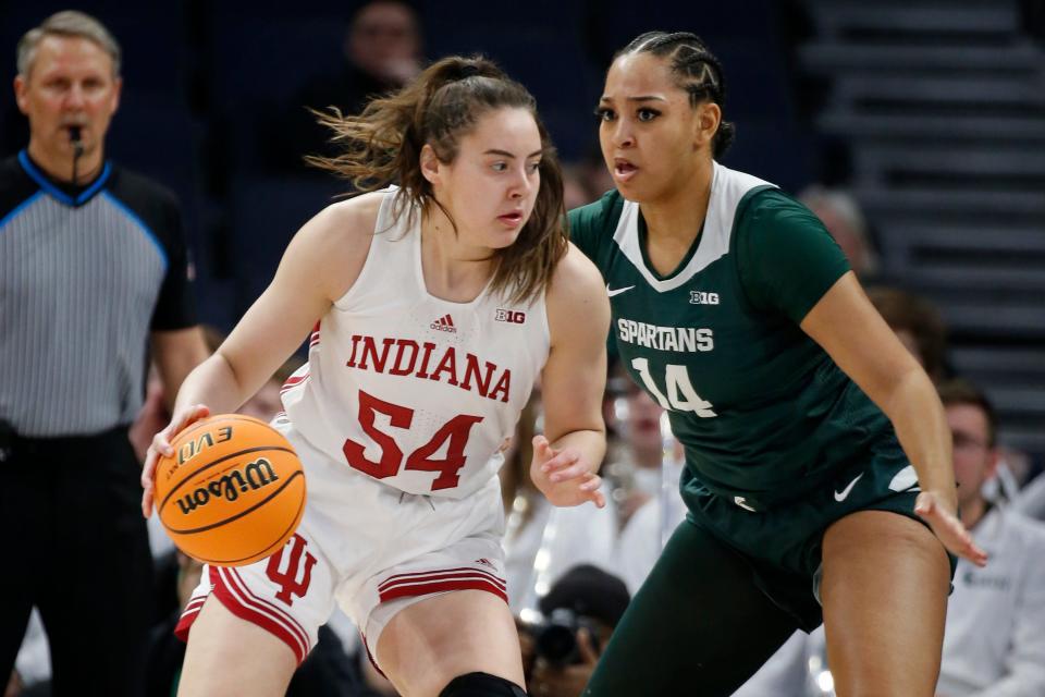 Indiana forward Mackenzie Holmes (54) drives against Michigan State forward Taiyier Parks (14) in the first half of an NCAA college basketball game at the Big Ten women's tournament Friday, March 3, 2023, in Minneapolis. (AP Photo/Bruce Kluckhohn)