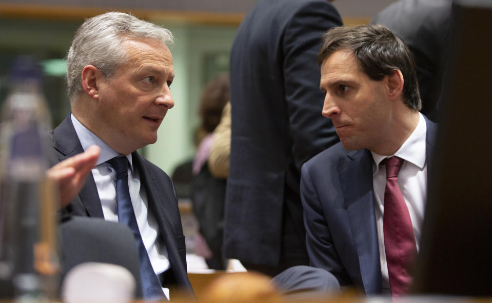 French Finance Minister Bruno Le Maire, left, speaks with Dutch Finance Minister Wopke Hoekstra during a meeting of EU finance ministers at the Europa building in Brussels, Tuesday, Feb. 18, 2020. EU finance ministers meet Tuesday to discuss tax havens. (AP Photo/Virginia Mayo)