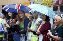 <p>Spectators shelter from the rain as they watch performers participating in the children’s day parade at the Notting Hill Carnival in London, Britain August 28, 2016.(Photo:Peter Nicholls/Reuters) </p>