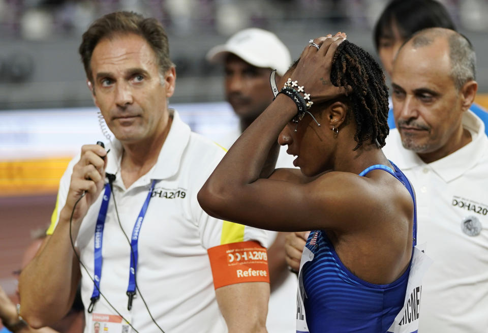 Brianna McNeal, of the United States reacts after being disqualified for a false start in a women's 100 meter hurdles heat at the World Athletics Championships in Doha, Qatar, Saturday, Oct. 5, 2019. (AP Photo/David J. Phillip)