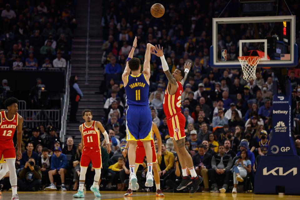 Golden State Warriors guard Klay Thompson (11) shoots over Atlanta Hawks forward John Collins, right, during the first half of an NBA basketball game in San Francisco, Monday, Jan. 2, 2023. (AP Photo/Jed Jacobsohn)