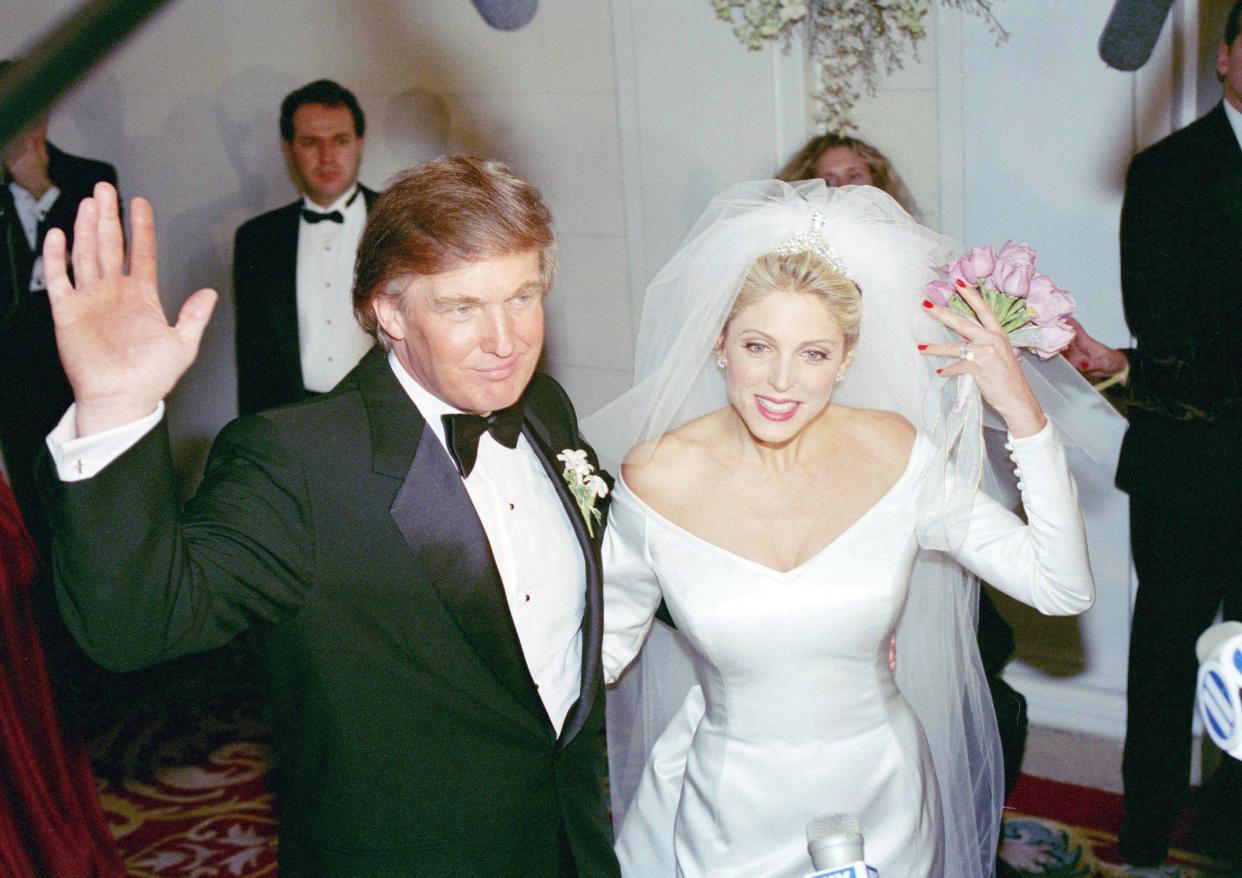 Donald and Marla Trump wave good bye to photographers as they enter their wedding reception in New York's Plaza Hotel, on Dec. 20, 1993. The developer and the model were married in a brief ceremony in the hotel's grand ballroom after a six-year relationship.