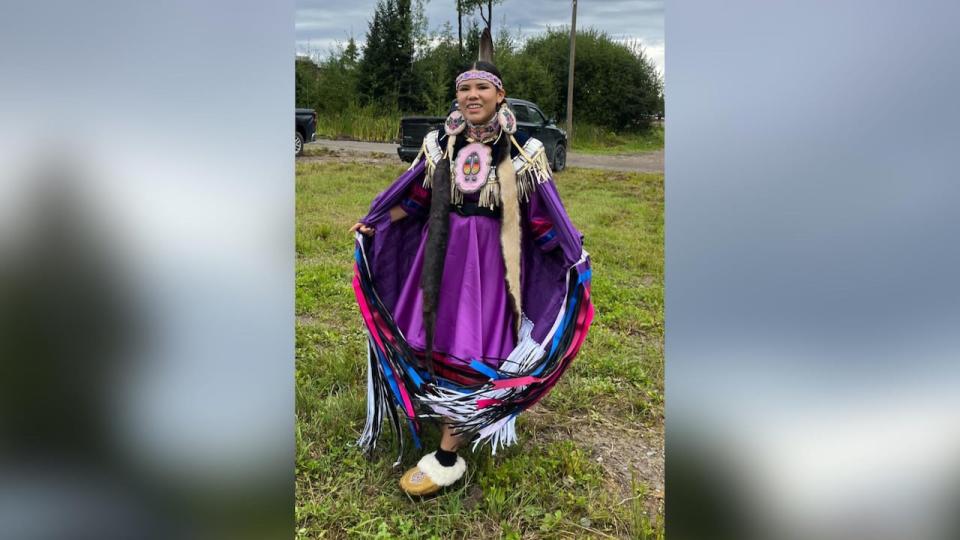 Sharlee Achneepineskum shows off her new regalia, put together with pieces donated by community members.