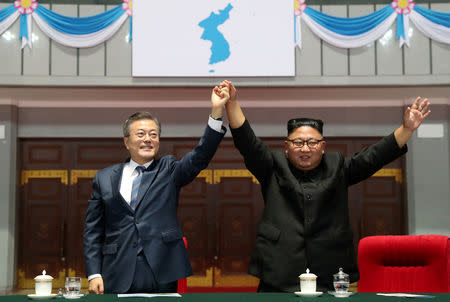 South Korean President Moon Jae-in and North Korean leader Kim Jong Un acknowledges the audience after watching the performance titled "The Glorious Country" at the May Day Stadium in Pyongyang, North Korea, September 19, 2018. Pyeongyang Press Corps/Pool via REUTERS