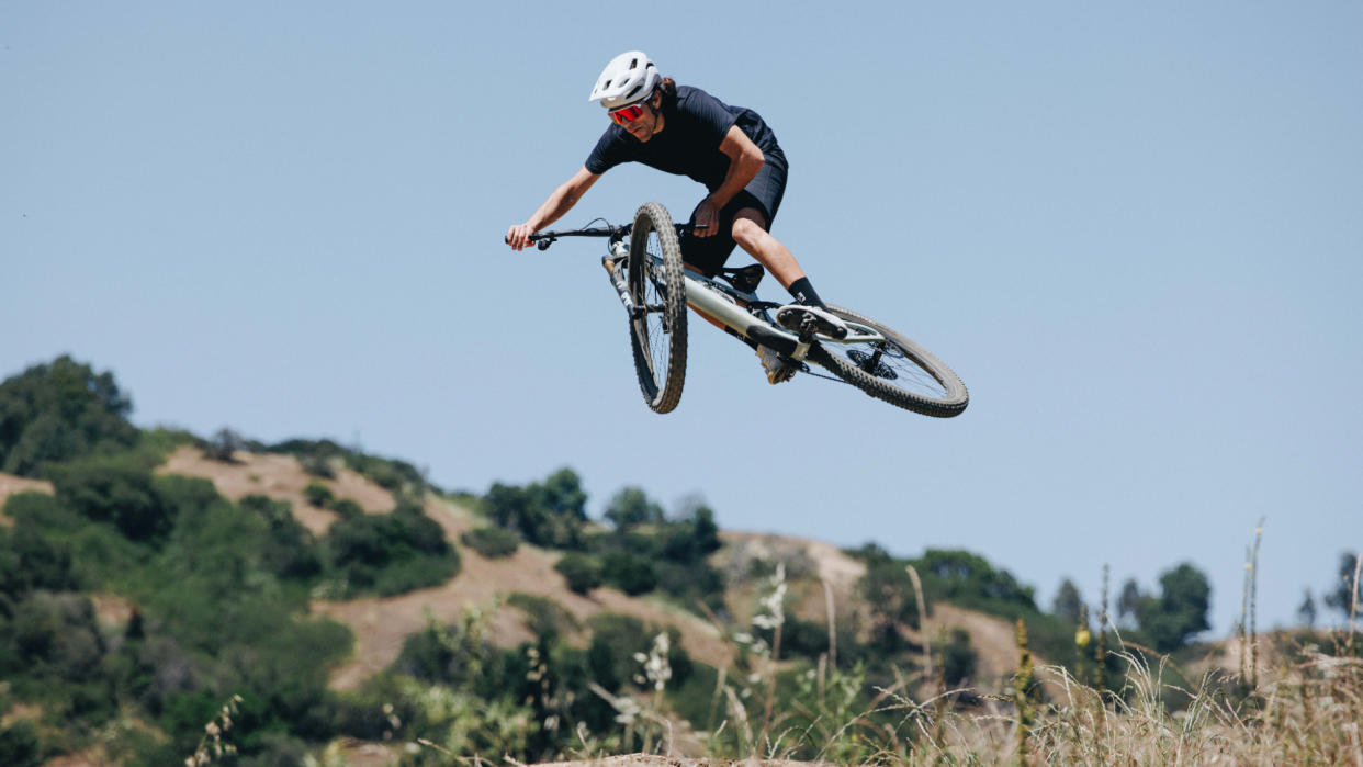  A man doing an air on a mountain bike. 