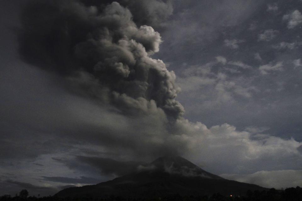 Mount Sinabung spews ash in a view from Tiga Pancur village in Karo district