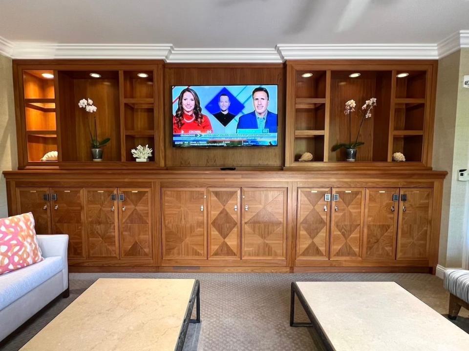 A TV surrounded by shelves and lockers in the Aloha Suite at the Four Seasons Maui at Wailea.