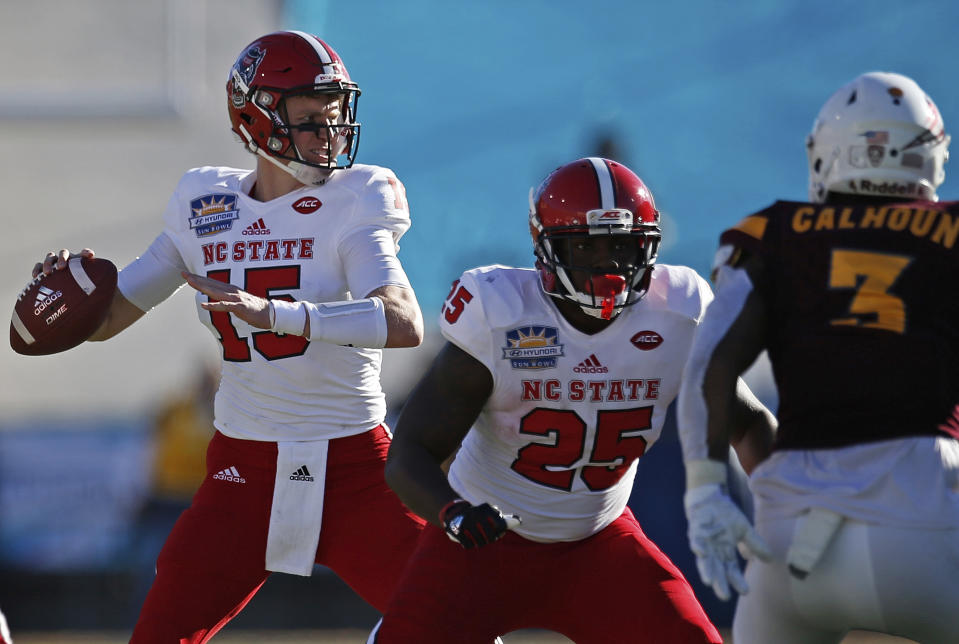 North Carolina State quarterback Ryan Finley, left, throws against Arizona State during the fist half of the Sun Bowl NCAA college football game in El Paso, Texas, Friday, Dec. 29, 2017. (AP Photo/Andres Leighton)