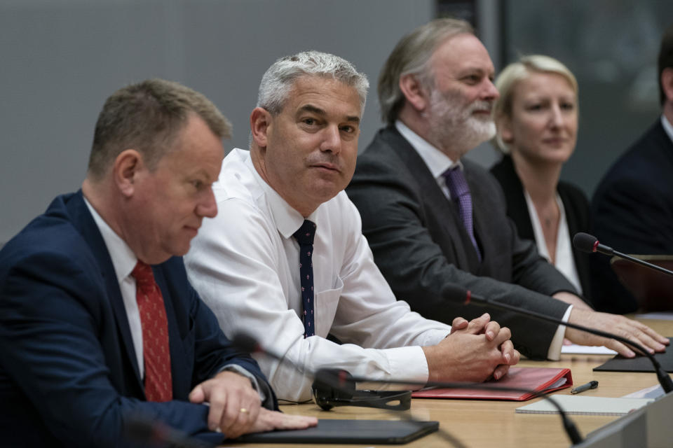 Britain's Brexit Secretary Stephen Barclay, second left, sits along with Britain's Brexit advisor David Frost, left, and British Ambassador to the EU Tim Barrow during a meeting with European Union chief Brexit negotiator Michel Barnier at the European Commission headquarters in Brussels, Friday, Sept. 20, 2019. (Kenzo Tribouillard/Pool via AP)