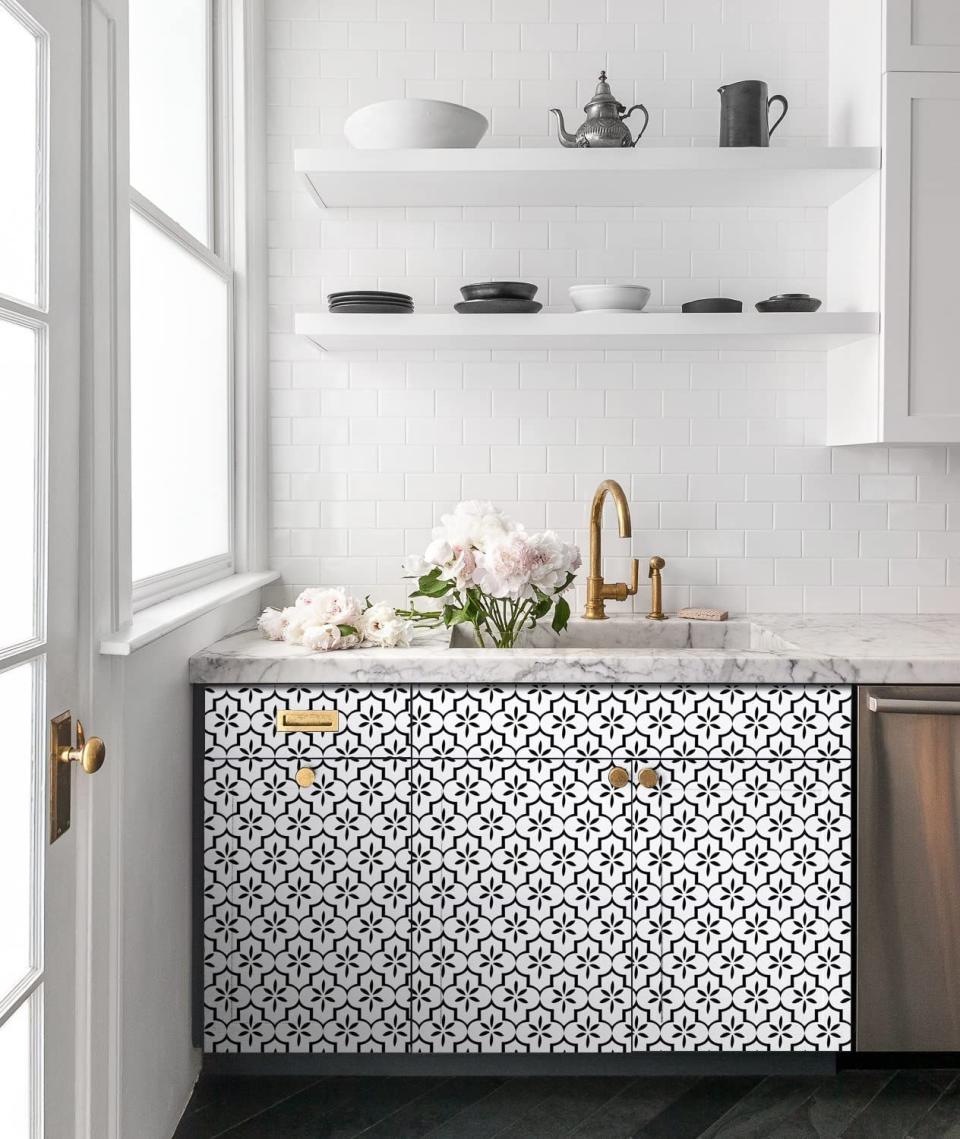 kitchen cabinets with patterned wallpaper on them