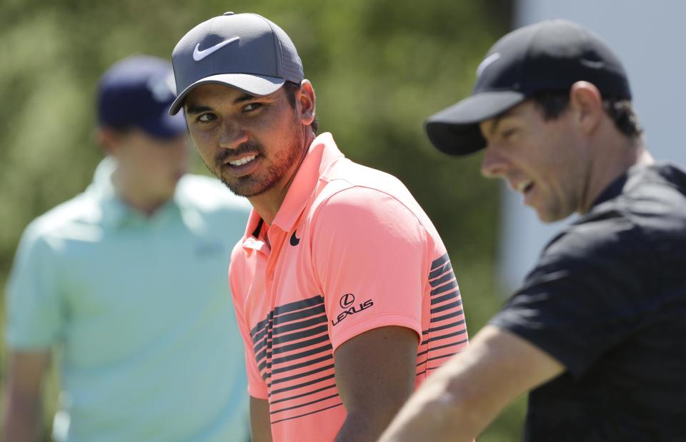 Defending champion Jason Day, of Australia, left, talks with Rory McIlroy, of Northern Ireland, right, as they practice for the Dell Technologies Match Play Championship golf tournament at Austin County Club, Tuesday, March 21, 2017, in Austin, Texas. (AP Photo/Eric Gay)
