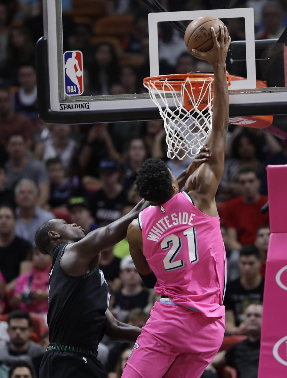 Miami Heat center Hassan Whiteside (21) shoots over Minnesota Timberwolves center Gorgui Dieng during the first half of an NBA basketball game, Sunday, Dec. 30, 2018, in Miami. (AP Photo/Lynne Sladky)