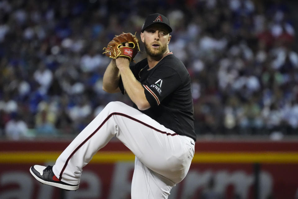 Arizona Diamondbacks starting pitcher Merrill Kelly throws against the Los Angeles Dodgers during the first inning of a baseball game Thursday, April 6, 2023, in Phoenix. (AP Photo/Ross D. Franklin)