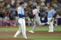 Tampa Bay Rays starting pitcher Tyler Alexander, left, reacts as New York Yankees' Jahmai Jones, back center, rounds the bases on a solo home run during the third inning of a baseball game Sunday, May 12, 2024, in St. Petersburg, Fla. (AP Photo/Mike Carlson)