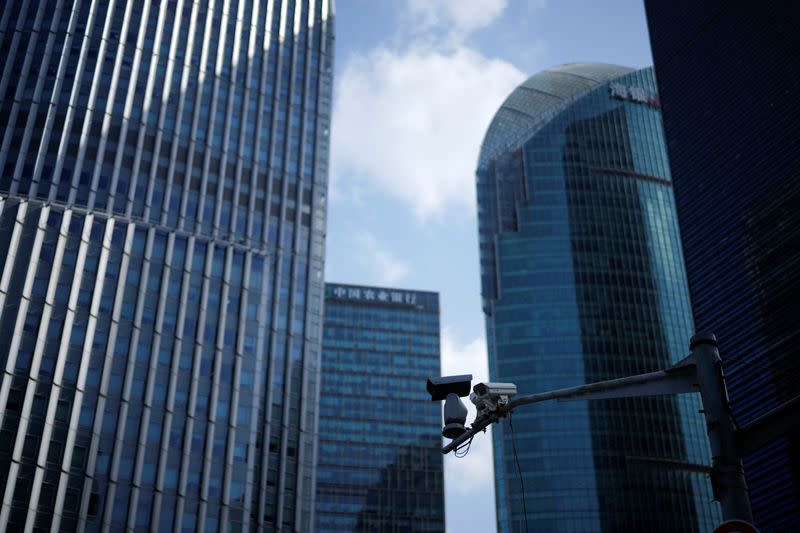 Surveillance cameras are seen in front office towers in the Lujiazui financial district, following the COVID-19 outbreak, in Shanghai