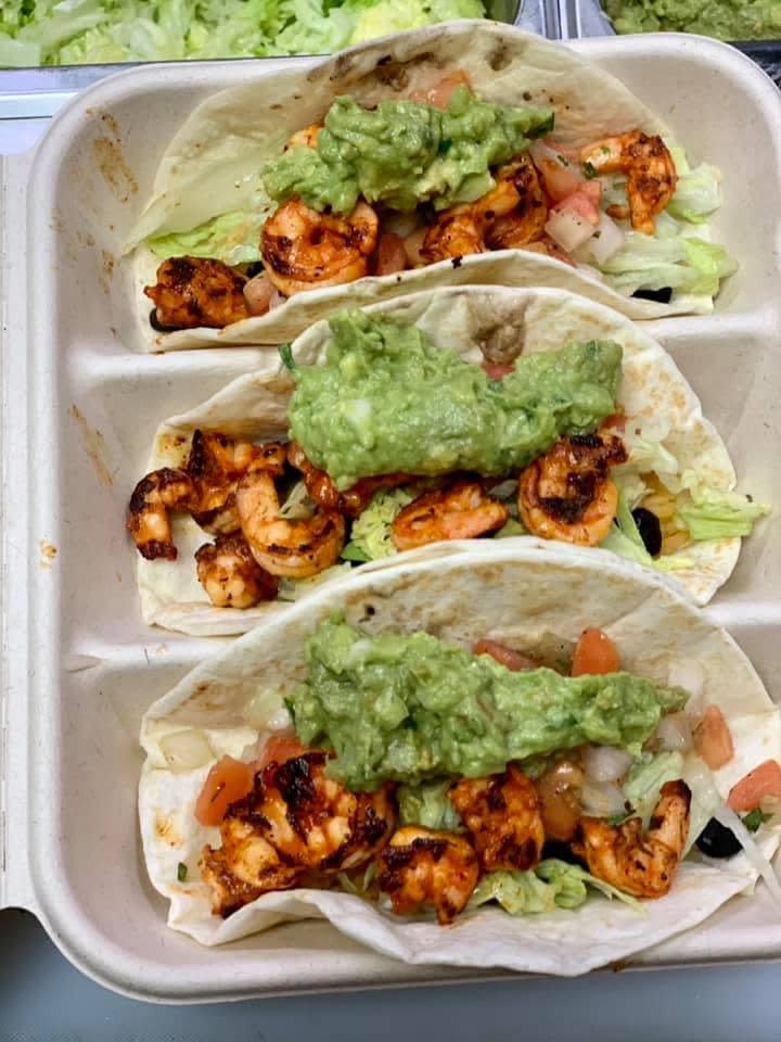 Guacamole sits atop shrimp tacos at Tijuana Burrito Grill.
