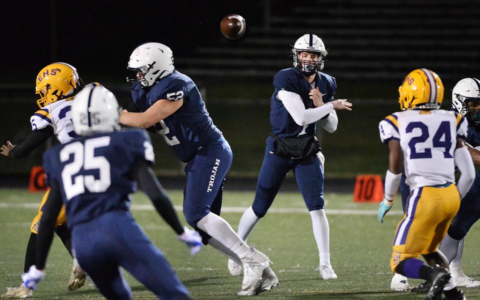 McDowell High School junior Blayze Myers, center, passes to junior Jake Hower (25) during the District 10 Class 6A championship game against Erie High at PennWest Edinboro's Sox Harrion Stadium in Edinboro on Nov. 3, 2023.