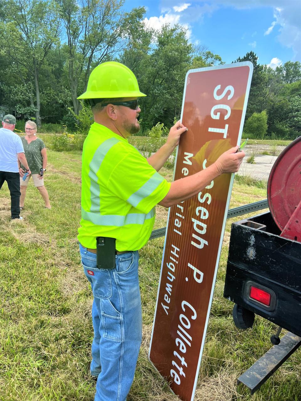 Ohio Department of Transportation employee Lenny Sheets prepares to erect a sign at Ohio 158 and Ginder Road honoring Army Sg.t Joseph Collette. Collette was killed in action while serving in Afghanistan in March 2019.