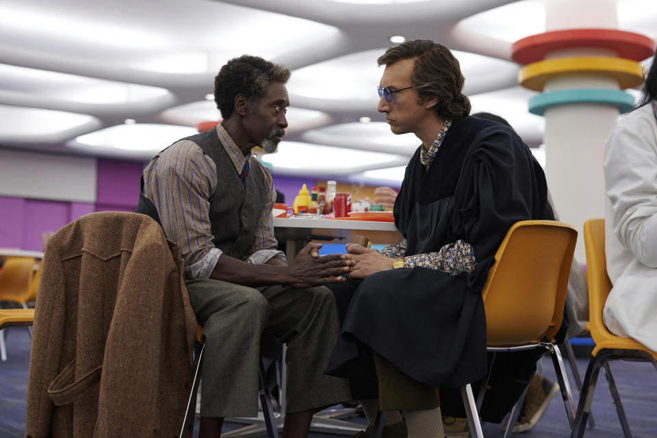 This image released by Netflix shows Don Cheadle, left, and Adam Driver in a scene from "White Noise." (Wilson Webb/Netflix via AP)