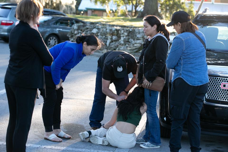 A shopper is overcome with emotion after the Dec. 23 shooting at the Paddock Mall.