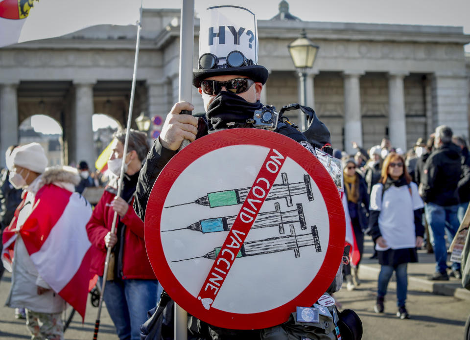 FILE - A man takes part in a demonstration against the country's coronavirus restrictions in Vienna, Austria, Saturday, Nov. 20, 2021. The coronavirus's omicron variant kept a jittery world off-kilter Wednesday Dec. 1, 2021, as reports of infections linked to the mutant strain cropped up in more parts of the globe, and one official said that the wait for more information on its dangers felt like “an eternity.” (AP Photo/Lisa Leutner, File)