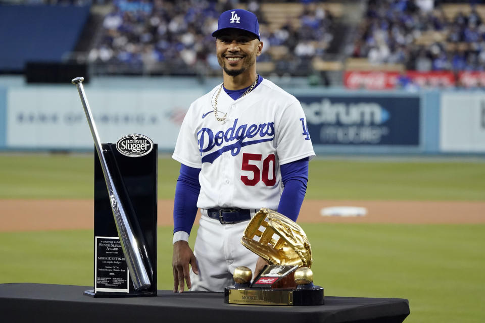 Los Angeles Dodgers' Mookie Betts (50) poses for a photo with the Silver Slugger and Golden Glove awards, given to him before the team's baseball game against the Colorado Rockies on Tuesday, April 4, 2023, in Los Angeles. (AP Photo/Marcio Jose Sanchez)