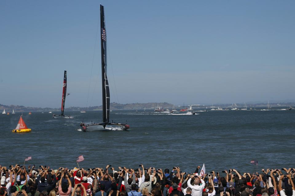 Oracle Team USA crosses the finish line ahead of Emirates Team New Zealand during Race 17 of the 34th America's Cup yacht sailing race in San Francisco, California September 24, 2013. REUTERS/Stephen Lam (UNITED STATES - Tags: SPORT YACHTING)