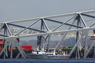 Salvage work continues on the collapsed Francis Scott Key Bridge, Monday, April 15, 2024, in Baltimore. The FBI confirmed that agents were aboard the Dali conducting court-authorized law enforcement activity. (AP Photo/Julia Nikhinson)