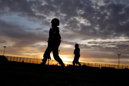 FILE PHOTO: Members of the Mexican National Guard patrol along the border fence between Mexico and the U.S. in Ciudad Juarez