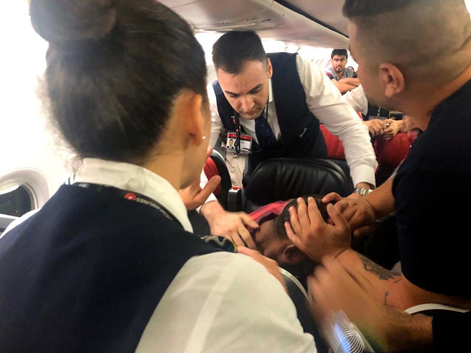 Passengers on a Turkish Airlines plane flying from Turkey to Sudan had to subdue a man who started screaming, tried to smash an oxygen mask box and then a cabin window, before pushing flight attendants aside and rushing towards the cockpit.Several passengers stopped the agitated man in the Boeing 737-900’s business class section after the uproar began only a few minutes after take off from Istanbul, according to Associated Press photographer Hussein Malla – on board the flight on Friday.Flight attendants spent around 15 minutes calming the man down and he was taken back to a seat as the plane continued to Khartoum.The crew said the man had complained about not being able to breathe. Around two hours into the flight, the pilots announced the plane was returning to Istanbul.A few minutes after the announcement, the same man stood up and pushed towards the front of the plane, where others grabbed him and shackled him with plastic restraints provided by flight attendants.Passengers were yelling in fear and children were crying, according to the AP photographer’s account.The plane landed back in Istanbul about three hours after it took off and police escorted the man off. As he departed, he shook hands with some passengers and kissed children.The airline did not immediately respond to requests for comment. There was no immediate word on where the man was taken. His identity was not released.Additional reporting by AP