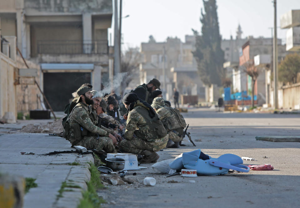 Image: Turkey-backed Syrian fighters rest in the town of Saraqib in Syria's Idlib province (Bakr Alkasem / AFP - Getty Images)