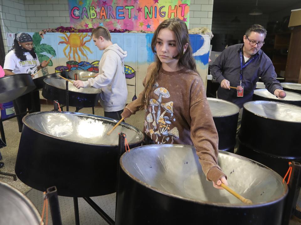Miller South student Cam Kucharski jams on the steel drums in class with teacher Matt Dudack, right, on Tuesday in Akron.