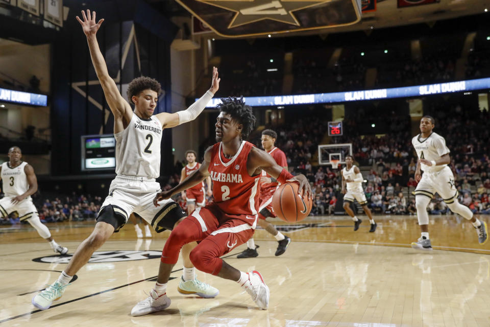 Alabama's Kira Lewis Jr., center, drives against Vanderbilt's Scotty Pippen Jr., left, in the first half of an NCAA college basketball game Wednesday, Jan. 22, 2020, in Nashville, Tenn. (AP Photo/Mark Humphrey)