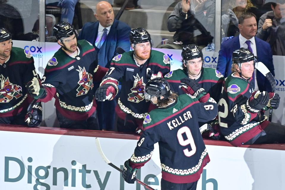 Arizona Coyotes right wing Clayton Keller (9) celebrates with teammates after scoring a goal in the first period at Mullett Arena in Tempe on March 14, 2023.