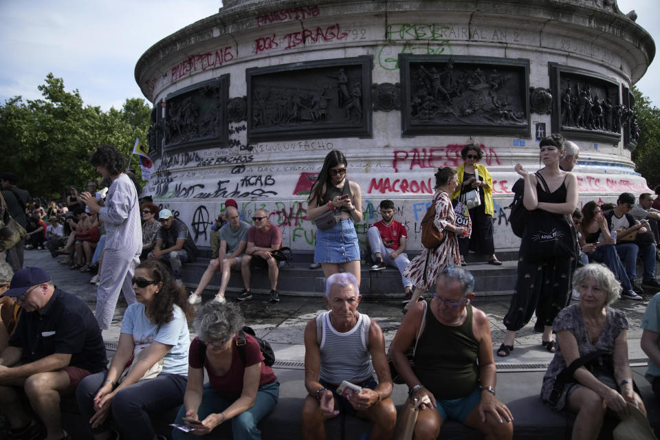 People gather on the Republique Plaza during a rally in Paris, Thursday June 27, 2024. Anti-racism groups joined French unions and left-wing coalition in protests against the surging nationalist far right as French President Emmanuel Macron called snap elections following the defeat of his centrist alliance at European Union elections earlier this month. (AP Photo/Christophe Ena)