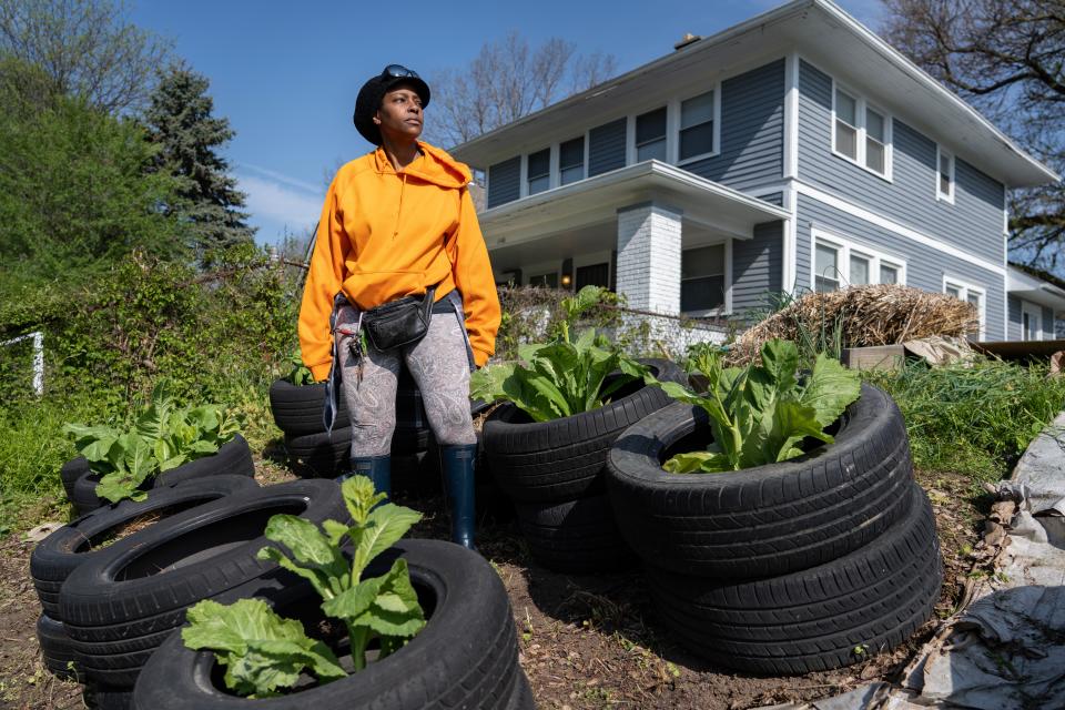 Tysha Ahmad stands in the garden she started on the west side of Indianapolis Wednesday, April 26, 2023. Residents and Ahmad are upset the communityÕs mulch was taken when city crews came to disposed of illegally dumped waste although much of the illegally dumped waste was left. 