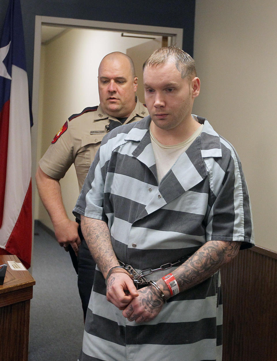 FILE - In this March 5, 2014 file photo, Don Willburn Collins walks into a hearing at the 359th Judicial District Court with Judge Kathleen Hamilton in Conroe, Texas. On Thursday, March 6, 2014, a judge ruled that Collins, 28, can be tried for murder in the death of Robert Middleton. Collins is accused of dousing Middleton with gasoline and setting him on fire. Middleton died from his burns nearly 13 years later. (AP Photo/ The Courier, Jason Fochtman, File) MANDATORY CREDIT