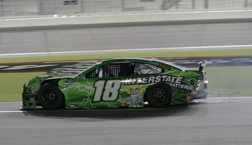 Kyle Busch drives his crashed car on pit road during the NASCAR Cup Series auto race at Daytona International Speedway, Saturday, Aug. 29, 2020, in Daytona Beach, Fla. Busch was leading when he hit the Turn 4 wall. (AP Photo/Terry Renna)