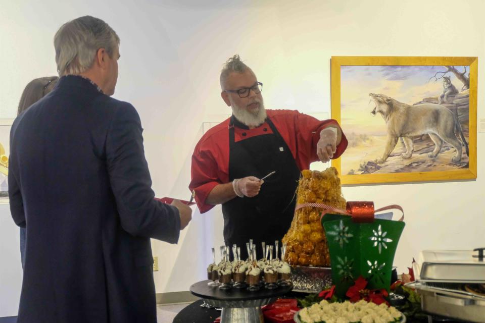 Guests look on as croquembouche's unique French dessert is served Thursday night at the 2nd annual Tidings of the Trees fundraiser event at the Panhandle-Plains Historical Museum in Canyon.