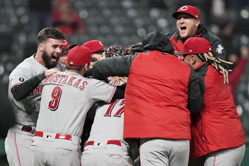 Cincinnati Reds teammates mob starting pitcher Wade Miley after he pitched a no-hitter in a baseball game against the Cleveland Indians, Friday, May 7, 2021, in Cleveland. (AP Photo/Tony Dejak)