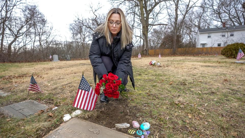 Lauren Lee Malloy at her mother's grave in East Providence. Her questions about her mother's 1993 death have led authorities to reexamine their original autopsy findings.
