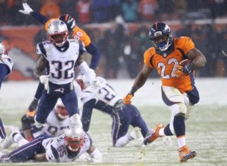 Denver Broncos running back C.J. Anderson (22) runs for the game winning touchdown during the overtime period against the New England Patriots at Sports Authority Field at Mile High. The Broncos won 30-24. Mandatory Credit: Chris Humphreys-USA TODAY Sports